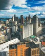 Vertical picture of buildings under a cloudy sky and sunlight in Detroit in Michigan, the USA