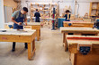 © Monkey Business - Wide Angle View Of Carpentry Workshop With Students Studying For Apprenticeship At College