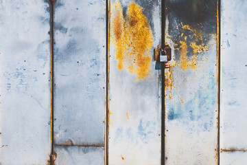 Master door stainless steel lock and master key at the old rusted and abandoned door.