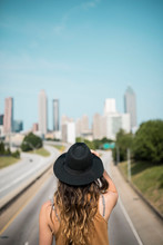 Hip Female Traveler Overlooking City Skyline In Atlanta Georgia
