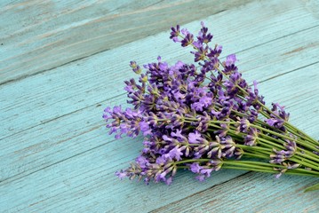 Wall Mural - Bouquet of lavender on an old blue wooden background in the style of Provence close up
