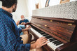 © chokniti - elderly dad and son are playing music at home, relax activity at home with family