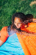 © Inti St. Clair - Girls playing on slip and slide in front yard of home
