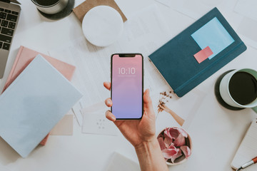 Wall Mural - Woman holding a smartphone