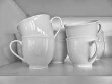 Close-up Of Tea Cups In Shelf