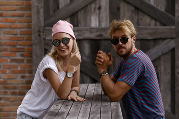 Close up romantic beauty portrait of happy hipster couple in love hugs and having fun, evening sunlight, stylish sunglasses, hat, emotions, joy, youth, sunny colors, hugs and kisses, fashion style.