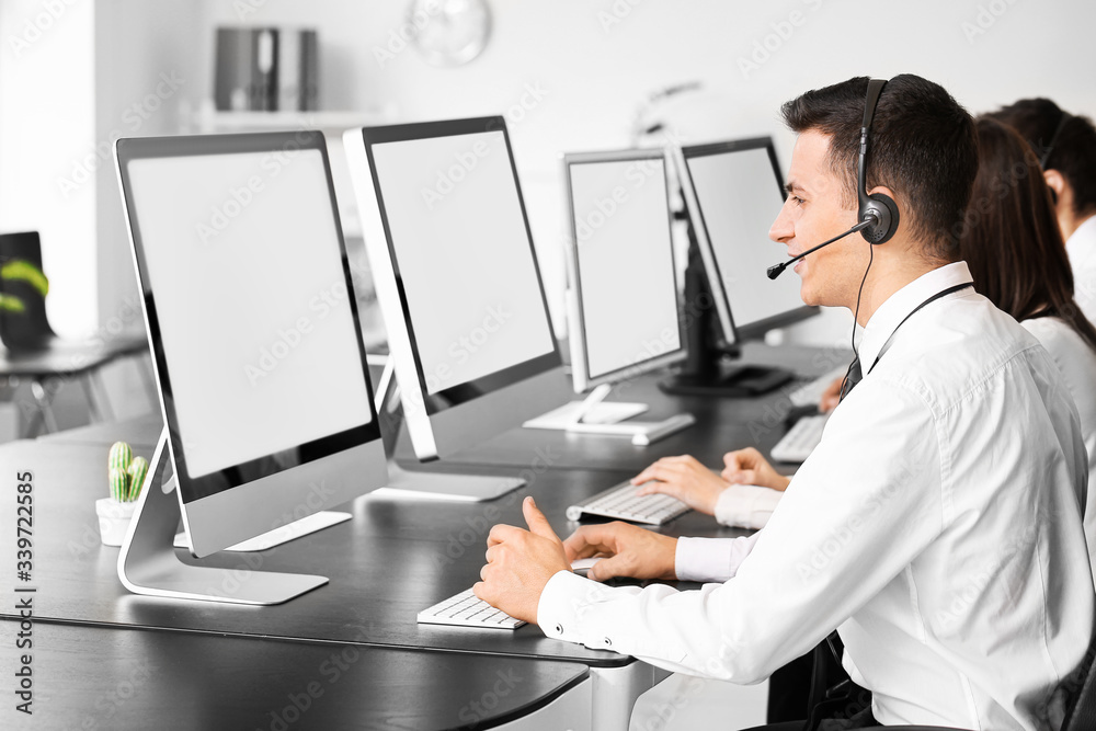 Team of technical support agents working in office