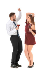 Wall Mural - Happy couple with glasses of wine on white background