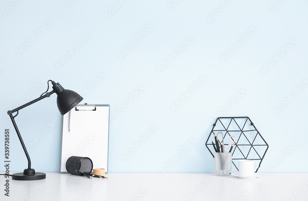 Modern stylish workplace near light wall