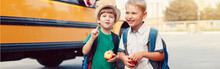 Two Funny Happy Caucasian Boys Students Kids With Apples Standing By Yellow Bus On 1 September Day. Education Back To School. Children Ready To Learn And Study. Web Banner Header For A Website.