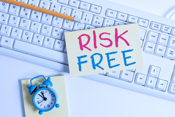 Wall Mural - Writing note showing Risk Free. Business concept for used to describe something that does not involve any danger Flat lay above empty note paper on the pc keyboard pencils and clock