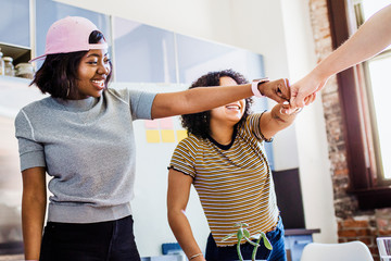 Wall Mural - Diverse team celebrate success with fist bump