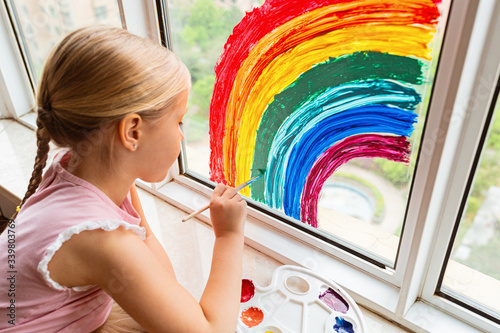 Fotografía Kid painting rainbow during Covid-19 quarantine at home