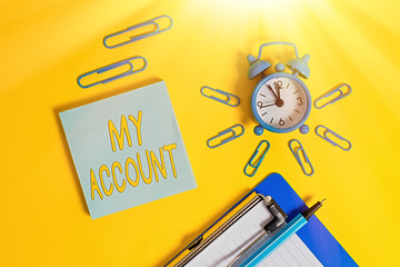 Poster - Handwriting text writing My Account. Conceptual photo If something is said to be on someone s is or something s is account Metal alarm clock clipboard clips ballpoint notepad colored background