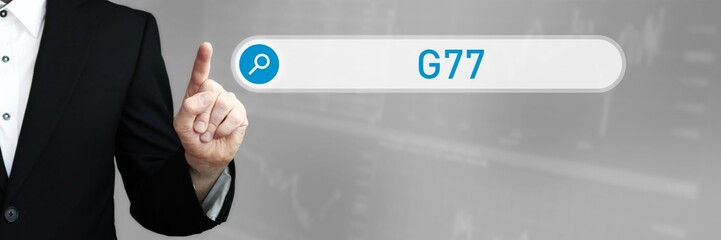 G77. Mann im Anzug zeigt mit dem Finger auf ein Suchfeld. Der Begriff G77 steht in der Suche. Symbol für Business, Finanzen, Statistik, Analyse, Wirtschaft