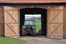 Tractor Seen From Open Doors Of Barn