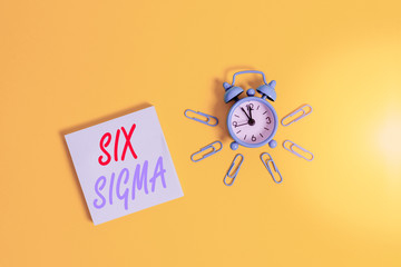 Conceptual hand writing showing Six Sigma. Concept meaning set of management techniques intended to improve business process Metal vintage alarm clock clips notepad colored background