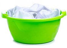 Green Plastic Bowl With Laundry Clothes On White Background Isolation