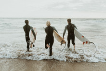 Surfer Team At The Beach