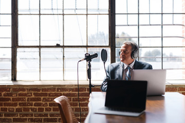 Wall Mural - Businessman recording a podcast