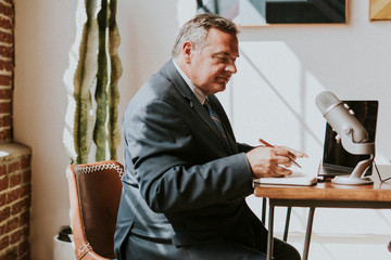 Wall Mural - Businessman recording a podcast