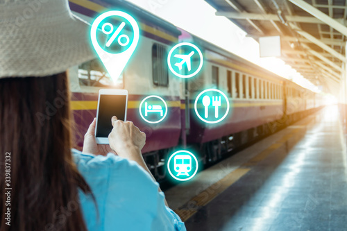 Cuadros en Lienzo Young backpacker tourist on train platform use wi-fi internet online smartphone