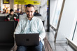 © F8  \ Suport Ukraine - Young handsome man working on a laptop in airport