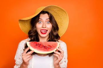 Wall Mural - Photo of curly wavy cheerful casual positive nice cap charming white youngster licking her upper lip holding a wedge of watermelon with lips pomaded willing to eat isolated over vivid color background