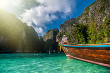 Handsome Man Tourist, Sitting On A Boat With Blue Turquoise Sea Water, On Blue Lagoon Of Phi Phi Island In Summer Season During Travel Holidays Vacation Trip.