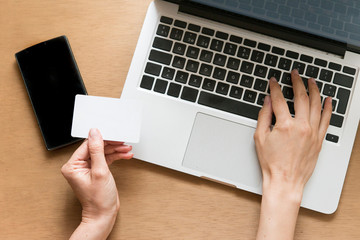 Top view of man using credit card for online shopping