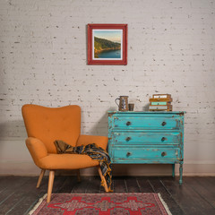 bright orange retro armchair with plaid against white brick wall with shabby chic vintage turquoise 