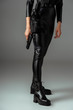 © LIGHTFIELD STUDIOS - partial view of  futuristic african american woman in glasses with gun on grey
