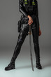 © LIGHTFIELD STUDIOS - cropped view of futuristic african american woman with sword on grey
