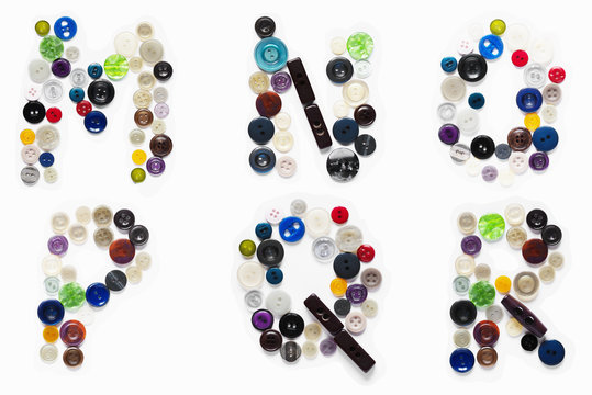 Miscellaneous colored buttons from clothes in the form of letters