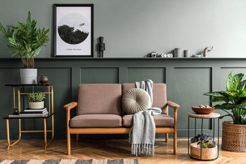 stylish interior design of living room at cozy apartment with stylish sofa, plants, design furniture