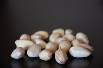 Pistachios on a dark wooden background