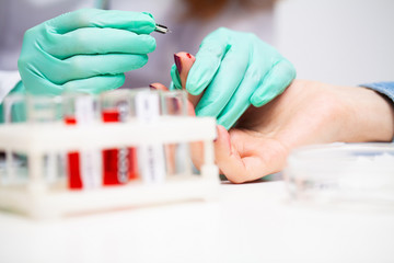 Woman at the hospital submits a blood test for a coronavirus