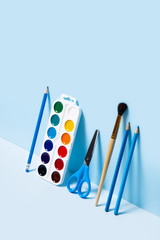 Wall Mural - School supplies on blue background. Back to school flat lay picture.