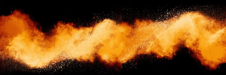 Wall Mural - freeze motion of orange color powder exploding on black background.