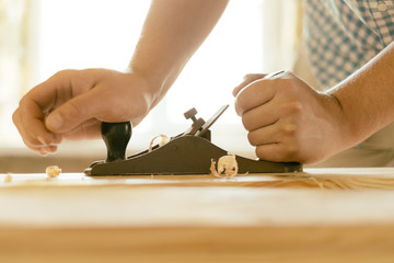 Hands working planer