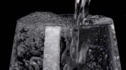 overflow water wastage in a transparent glass closeup