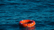 Life buoy or rescue buoy floating on sea to rescue people from drowning man.