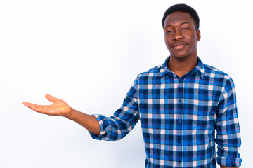 Wall Mural - Young handsome African man against white background