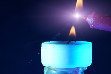 burning candles on blue background