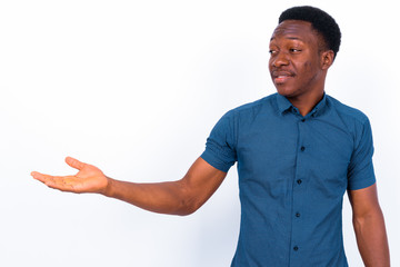 Wall Mural - Young handsome African man against white background