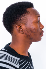 Wall Mural - Young handsome African man against white background