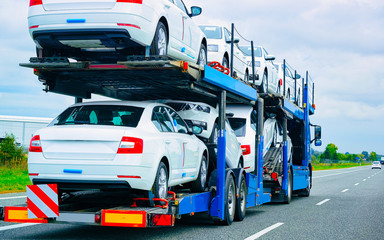 car carrier truck at asphalt road of poland reflex