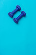 © Augustas Cetkauskas - Two dumbbells of blue color isolated on a light blue background. Healthy lifestyle concept.