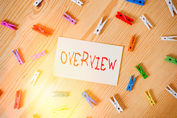 Poster - Handwriting text Overview. Conceptual photo the general review or summary of subject project movie book Colored clothespin papers empty reminder wooden floor background office