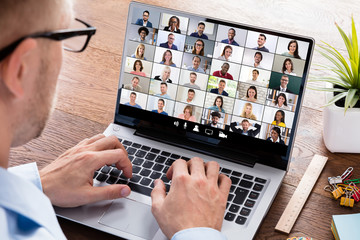 Wall Mural - Businessperson Videoconferencing On Laptop